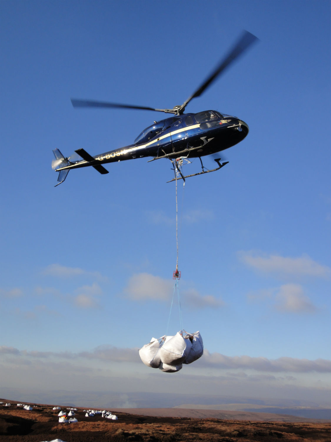 Helicopter transporting heather brash