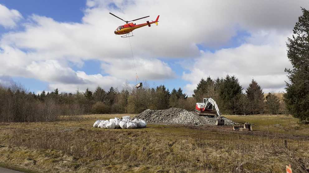 Transporting materials to site with a helicopter